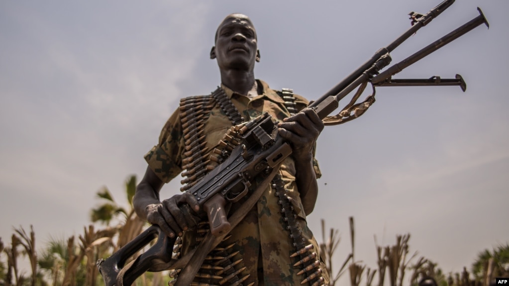 A rebel soldier poses with his gun in Touch Riak, Leer county, on March 7, 2018, where famine has been declared since February 2017. The ICRC left the area after gunmen fired on the organization's compound.