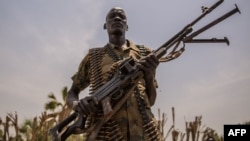 A rebel soldier poses with his gun in Touch Riak, Leer county, on March 7, 2018, where famine has been declared since February 2017. The ICRC left the area after gunmen fired on the organization's compound.