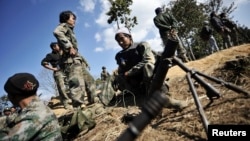 FILE - Kachin rebels are seen manning their positions at near Mai Ja Yang, Kachin state.