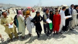 In this Aug. 17, 2021, file photo, hundreds of people gather outside the international airport in Kabul, Afghanistan. (AP Photo/File)