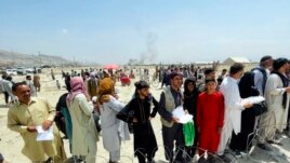 In this Aug. 17, 2021, file photo, hundreds of people gather outside the international airport in Kabul, Afghanistan. (AP Photo/File)