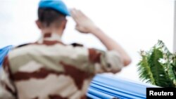 A soldier salutes UN Special Representative to Mali, Albert Koenders (2nd L), at a ceremony that marks the beginning of the 12,000-strong U.N. peacekeeping mission in Mali in Bamako, July 1, 2013. 