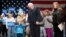 Democratic presidential candidate Sen. Bernie Sanders, I-Vt., center, is joined by his wife Jane, right, and grandchildren, Dylan, 4, and Ella, 7, on stage after speaking at a town hall at the Orpheum Theater in Sioux City, Iowa, Jan. 19, 2016.