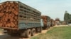 FILE - Trucks loaded with timber wait at the Cambodian border post of Bavet for clearance to cross into Vietnam. As the logs appear to be "unprocessed," export would be illegal under Cambodian law.