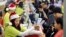 Shoppers pay for their purchases at an Old Navy store as "Black Friday" shoppers get an early start at the Citadel outlet stores on Thanksgiving in Los Angeles, California November 24, 2011