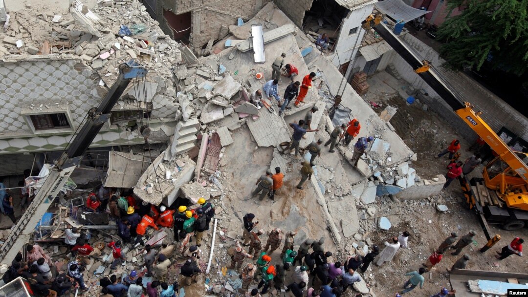 Petugas SAR di Karachi, Pakistan mencari lebih banyak korban setelah gedung bertingkat tiga runtuh Selasa pagi (18/7). 