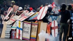 Anti-government protesters using handmade shields face off with security forces blocking a student march from reaching the Education Ministry in Caracas, Venezuela, May 8, 2017. 