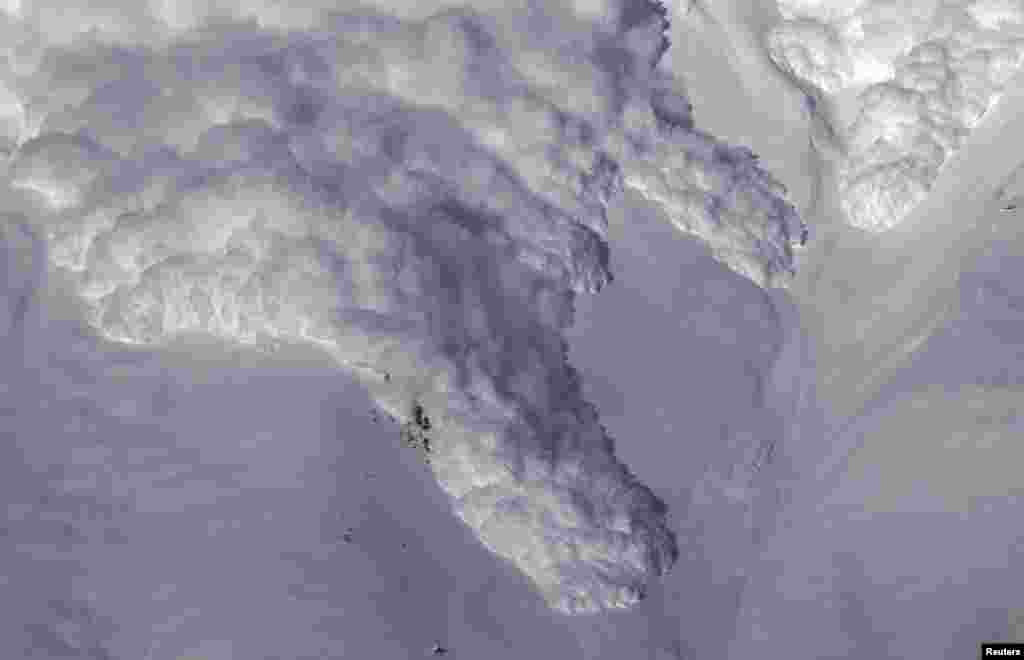 An artificially triggered avalanche thunders down a mountain side at the Vallee de la Sionne in Anzere near Sion, Switzerland. The full-scale avalanche dynamics test site is providing scientists and engineers of the Swiss Institute of Research of Snow and Avalanches with essential data to understand and model avalanche motion, according to the Institute website.