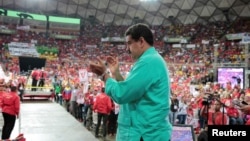 FILE - Venezuela's President Nicolas Maduro applauds as he attends a rally in Caracas, Venezuela, June 11, 2016. With the OPEC nation's economy immersed in crisis, various foreign companies have been pulling out of Venezuela or reducing operations in the country.