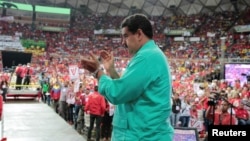 Venezuela's President Nicolas Maduro applauds as he attends a rally in Caracas, Venezuela, June 11, 2016.