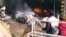 FILE - Vehicles are on fire after a blast in Peshawar, Pakistan, Dec. 5, 2009. 