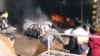 FILE - Vehicles are on fire after a blast in Peshawar, Pakistan, Dec. 5, 2009. 