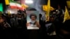 A cleric holds a poster of slain Hezbollah leader Hassan Nasrallah during an anti-Israeli gathering celebrating Iran's missile strike against Israel at Felestin Square in Tehran, Iran, Oct. 1, 2024.