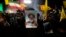 A cleric holds a poster of slain Hezbollah leader Hassan Nasrallah during an anti-Israeli gathering celebrating Iran's missile strike against Israel at Felestin Square in Tehran, Iran, Oct. 1, 2024.