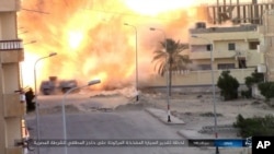 FILE - This photo posted on a file-sharing website Jan. 11, 2017, by the Islamic State Group in Sinai, a militant organization, shows an explosion as militants attack an Egyptian police checkpoint, Jan. 9, 2017, in el-Arish, north Sinai, Egypt.