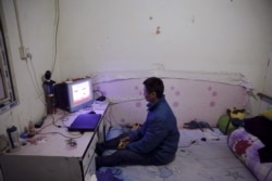 Jiang Shuaihui, 25, a worker from Henan province plays video games in a room he is renting in Tongzhou district of Beijing, Feb. 25, 2016.