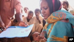 Sudanese women receives information about childhood immunizations.