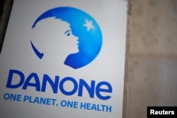 FILE - The logo of French food group Danone hangs at the company headquarters in Paris, Feb. 5, 2024.