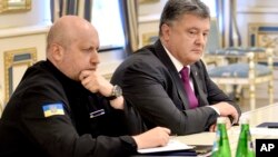 FILE - Ukraine's President Petro Poroshenko, right, and Oleksandr Turchynov, Head of Ukraine's Security and Defense Council, chair a council session in Kyiv, Ukraine, Aug. 11, 2016. Poroshenko on Tuesday ordered an official inquiry into whether any Ukraine-made missile engine technology could have been supplied to North Korea.