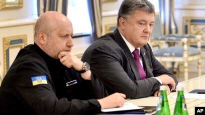 FILE - Ukraine's President Petro Poroshenko, right, and Oleksandr Turchynov, Head of Ukraine's Security and Defense Council, chair a council session in Kyiv, Ukraine, Aug. 11, 2016. Poroshenko on Tuesday ordered an official inquiry into whether any Ukraine-made missile engine technology could have been supplied to North Korea.