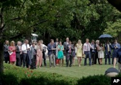 FILE - Journalists wait in the Rose Garden of the White House in Washington, for the signal to proceed forward as they wait to attend a statement by President Donald Trump and European Commission president Jean-Claude Juncker, July 25, 2018.
