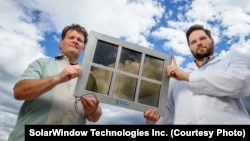 John Conklin (left) and Scott Hammond of SolarWindow Technologies Inc. with their transparent solar cell