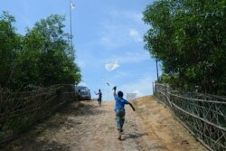 Rohingya refugee children fly kites in Kutupalong refugee camp in Ukhia on Oct. 11, 2020.