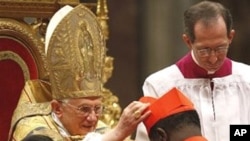 Newly-elevated Cardinal Laurent Monsengwo Pasinya, of the Democratic Republic of Congo, receives the red three-cornered biretta hat from the Pope during a consistory inside St. Peter's Basilica, at the Vatican, 20 Nov 2010