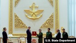 U.S. Secretary of State John Kerry receives a gift from Myanmar Commander-in-Chief Min Aung Hliang, following a bilateral meeting at the Commander-in-Chief's Compound in Naypyitaw, Myanmar, May 22, 2016.