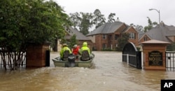 Volunteer rescue boats enter a flooded subdivision looking to evacuate residents as floodwaters from Tropical Storm Harvey rise in Spring, Texas, Aug. 28, 2017.