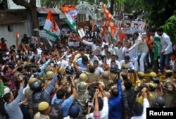 FILE - Supporters of India's main opposition Congress Party scuffle with police during a protest demanding the arrest of Kuldeep Singh Sengar, a state legislator from India's ruling Bharatiya Janata Party (BJP), in Lucknow, India, April 12, 2018.