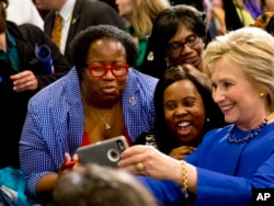 FILE - Democratic presidential candidate Hillary Clinton takes pictures with supporters after a campaign event at the Central Baptist Church in Columbia, South Carolina, Feb. 23, 2016.