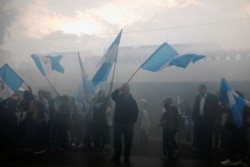 Demonstrators gather outside the premises of the International Commission against Impunity in Guatemala (CICIG) to celebrate the last day of the mandate of the anti-corruption commission, in Guatemala City, Guatemala, Sept. 3, 2019.