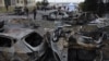 Local residents inspect burnt-out cars in the courtyard of a residential building following a drone attack in Odesa, Ukraine, on Nov. 9, 2024.