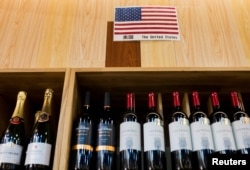 FILE - The U.S. flag is seen in the wine section of a supermarket in Beijing, China, April 5, 2018.