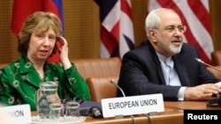 FILE: European Union foreign policy chief Catherine Ashton, left, and Iranian Foreign Minister Mohammad Javad Zarif smile at the start of nuclear talks in Vienna April 8, 2014. 