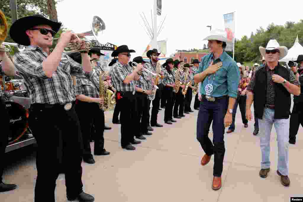 Canadian Prime Minister Justin Trudeau listens to the Calgary Stampede Show Band as they play for him at the Calgary Stampede in Calgary, Alberta, July 15, 2017.