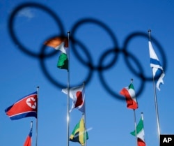 The North Korean flag, left, flies among flags from other nations at the Olympic Village at the 2018 Winter Olympics in Gangneung, South Korea, Feb. 1, 2018.