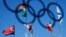 The North Korean flag, left, flies among flags from many nations at the Olympic Village at the 2018 Winter Olympics in Gangneung, South Korea, Feb. 1, 2018.