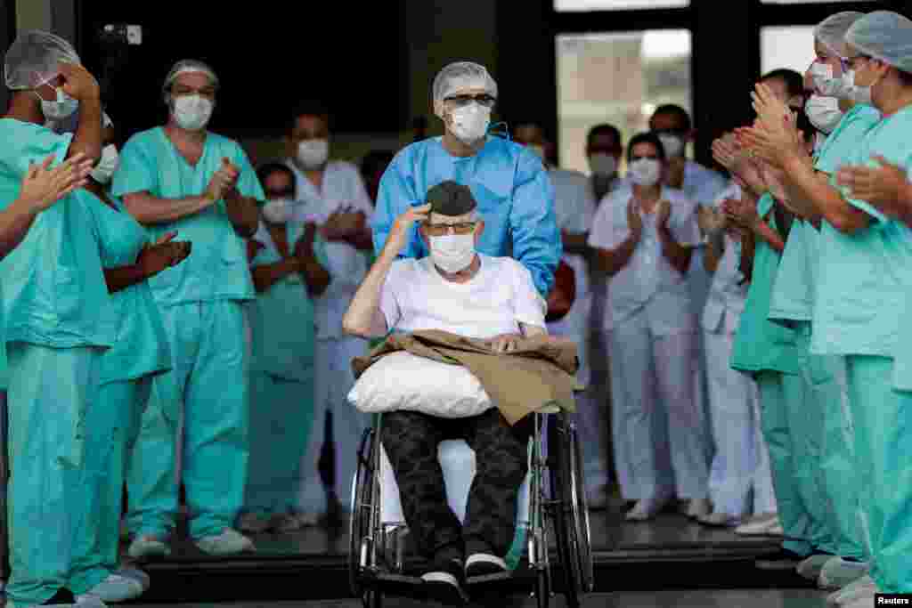 99-year-old former Brazilian WWII combatant Ermando Armelino Piveta gestures as he was discharged from the Armed Forces Hospital in Brasilia, April 14, 2020, after being treated for the coronavirus disease (COVID-19).