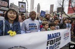 FILE - U.S. Rep. John Lewis leads a march of thousands through the streets of Atlanta, March 24, 2018. Participants in Atlanta and across the nation rallied against gun violence and in support of stricter gun control.