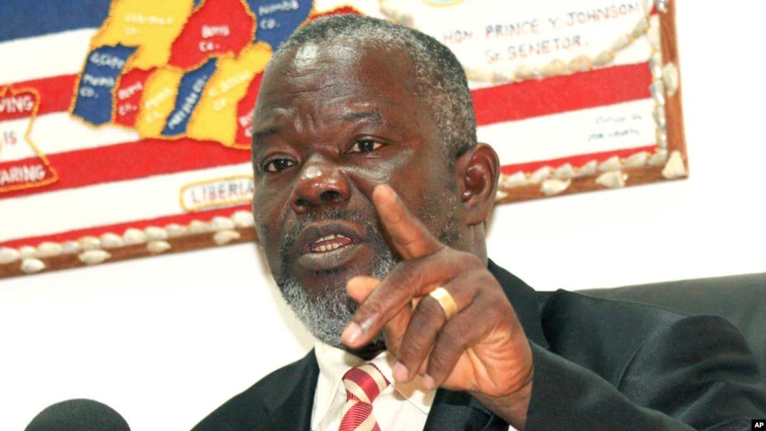 FILE - In this photo taken Feb. 17, 2010, Liberian Senator Prince Johnson gestures during an interview in Monrovia, Liberia. 