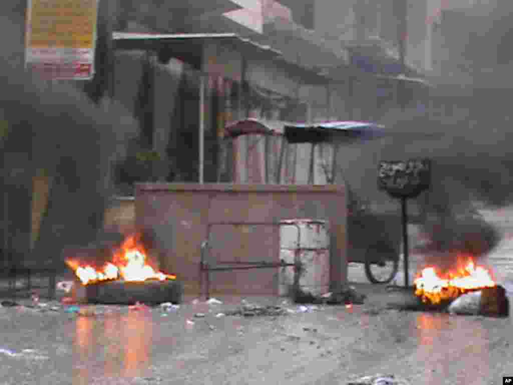 Tires burn on a street in Marat al-Numan, near Idlib, January 15, 2012. (Reuters)