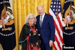 U.S. President Biden stands with National Humanities Medal recipient Henrietta Mann, Cheyenne, at the White House, March 21, 2023. Reuters/Kevin Lamarque