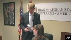 Tim Embree, a reservist who served two combat tours in Iraq and now works for the reputable Iraq Afghanistan Veterans Association (IAVA), speaks with a colleague, February 2011