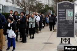 Congressional staffers wait in an excessively long line to enter the Dirksen Senate office building during the third day of a shut down of the federal government in Washington, Jan. 22, 2018.