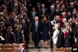 President Donald Trump, accompanied by first lady Melania Trump, arrive for a National Prayer Service at the National Cathedral, in Washington, Jan. 21, 2017.