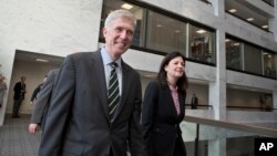 Supreme Court Justice nominee Neil Gorsuch, escorted by former New Hampshire Sen. Kelly Ayotte, arrives for a closed-door meeting with Sen. Jon Tester, D-Mont., at his office on Capitol Hill in Washington, Feb. 6, 2017. 