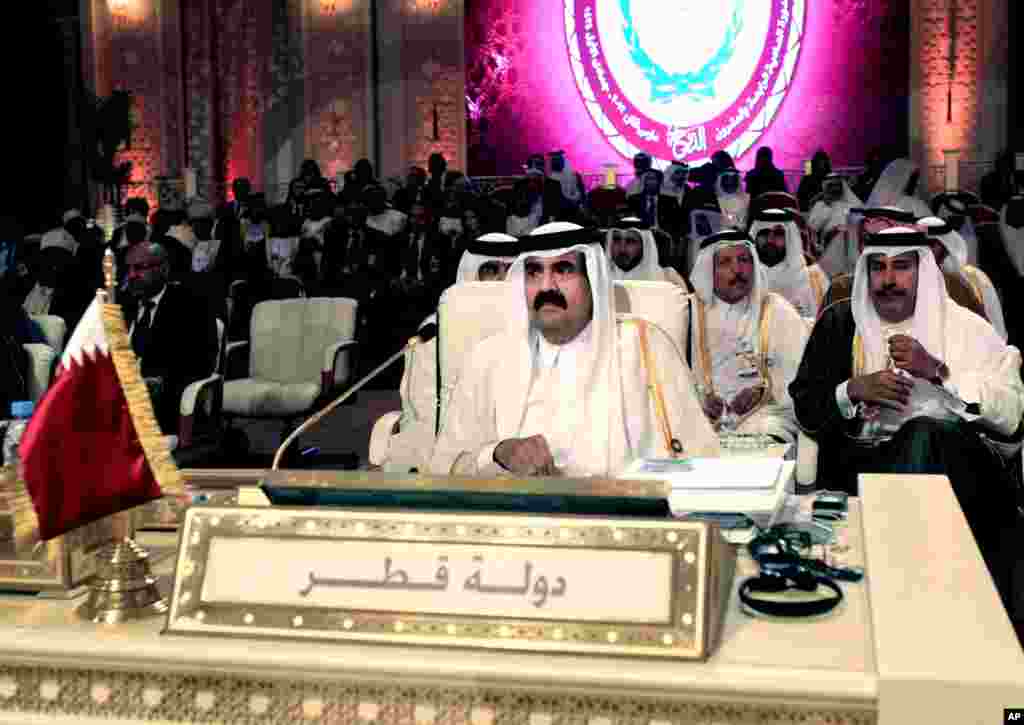 In this March 26, 2013 file photo, Emir of Qatar Sheik Hamad Bin Khalifa al-Thani, center, attends the opening session of the Arab League Summit in Doha.