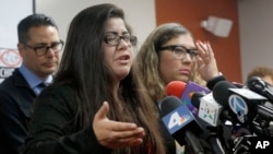 Marlene Mosqueda (left) whose father was arrested by ICE agents early Friday morning, talks at a news conference with her attorney Karla Navarrette, Feb. 10, 2017. Navarrete said another lawyer filed federal court papers to halt his removal.